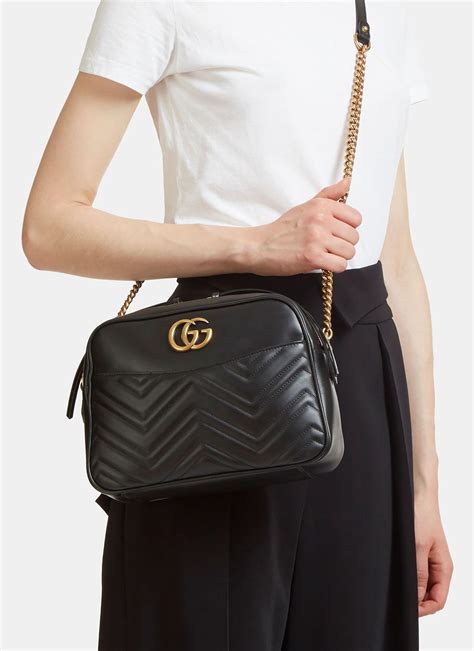 GG Matelassé small shoulder bag in black leather .